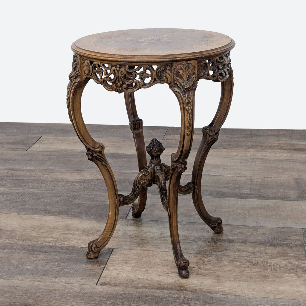 a small round table with a carved top.