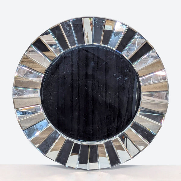 a large circular mirror with a black and white glass frame.