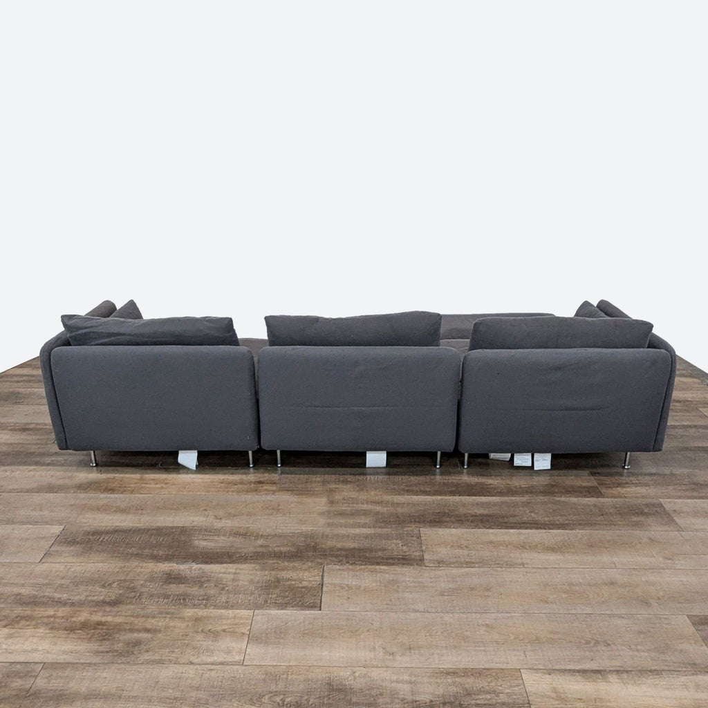 Back view of IKEA SÖDERHAMN sectional sofa with grey upholstery and metal legs.