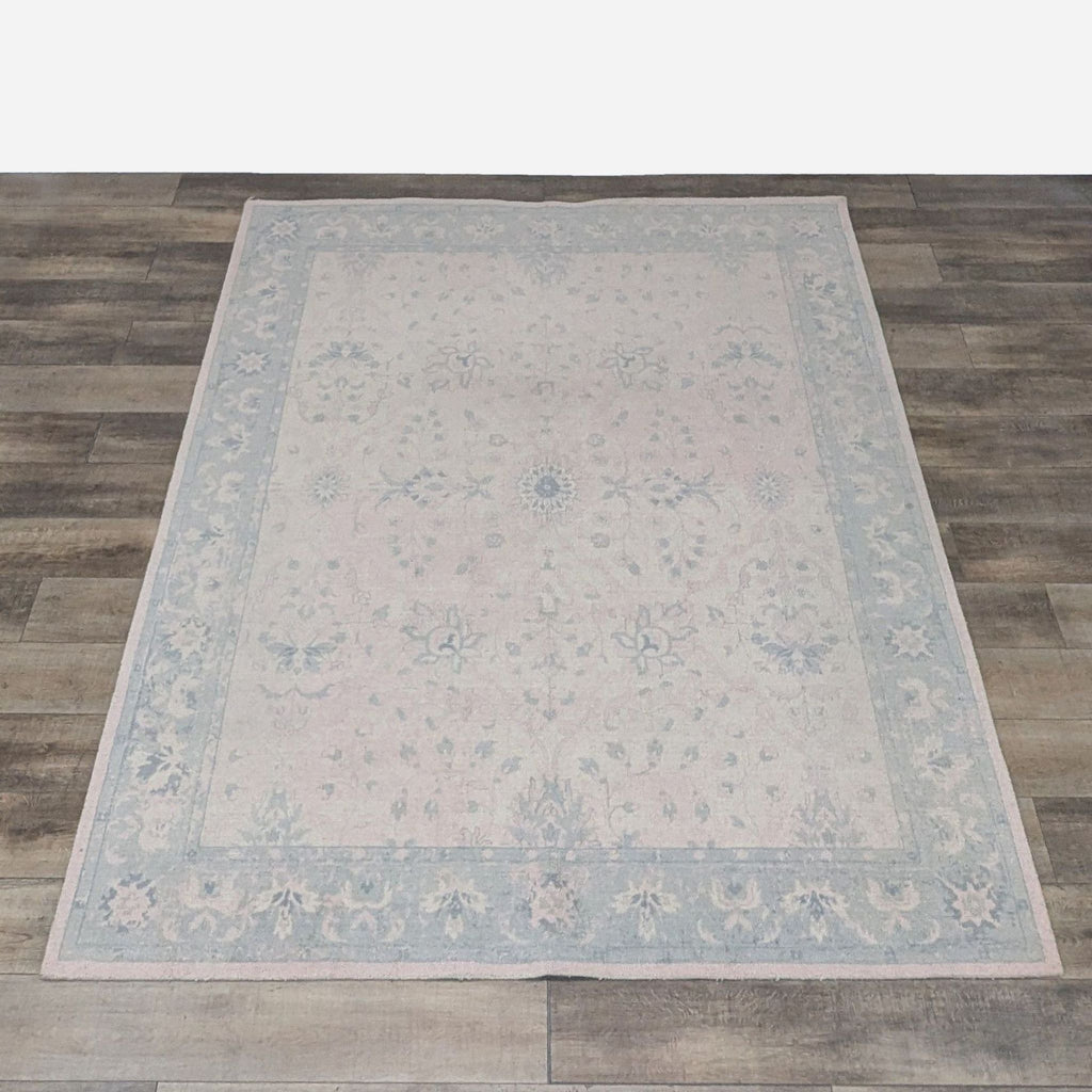 Top view of Pottery Barn Kids 8'x10' blush pink wool area rug showing its full design.