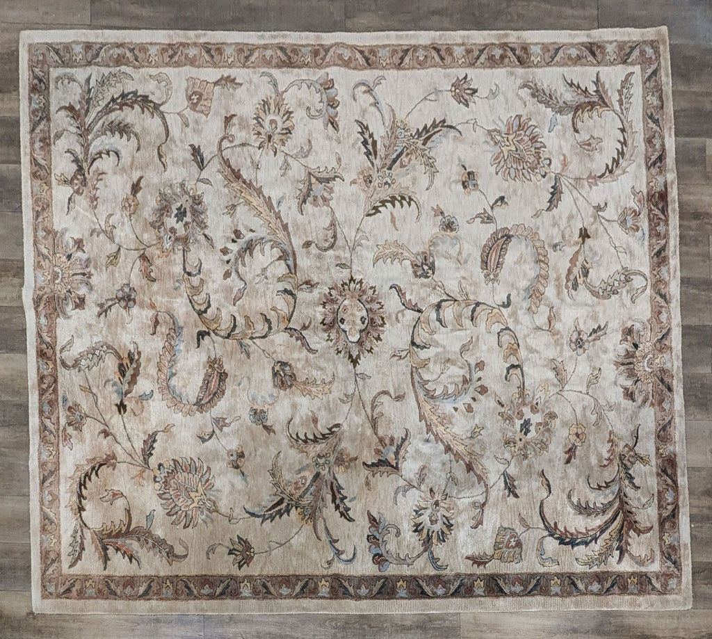 Monaco tan hand-tufted rug with intricate floral and leaf designs on a viscose pile.