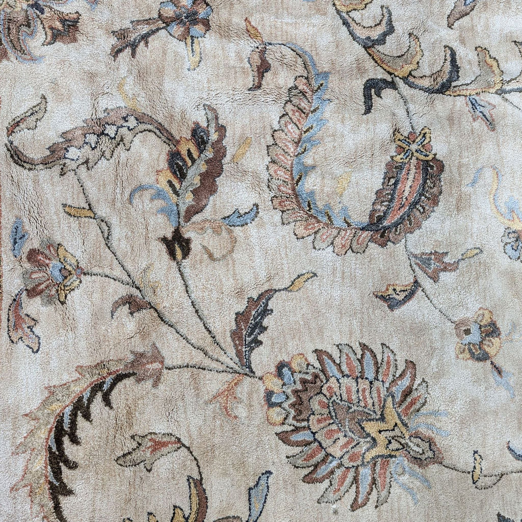 Close-up view of the hand-tufted floral and leaf patterns on Monaco tan Viscose pile rug.