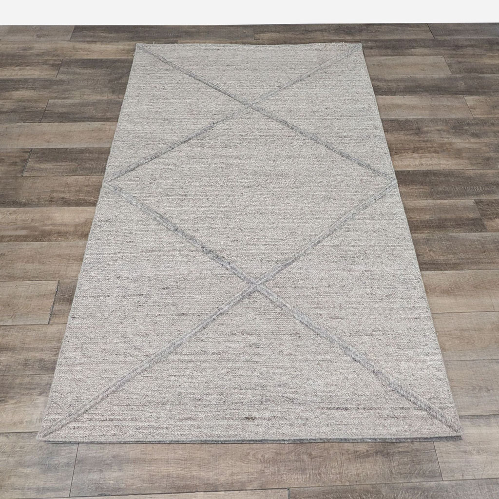 the gray rug is a modern, contemporary rug with a geometric pattern.