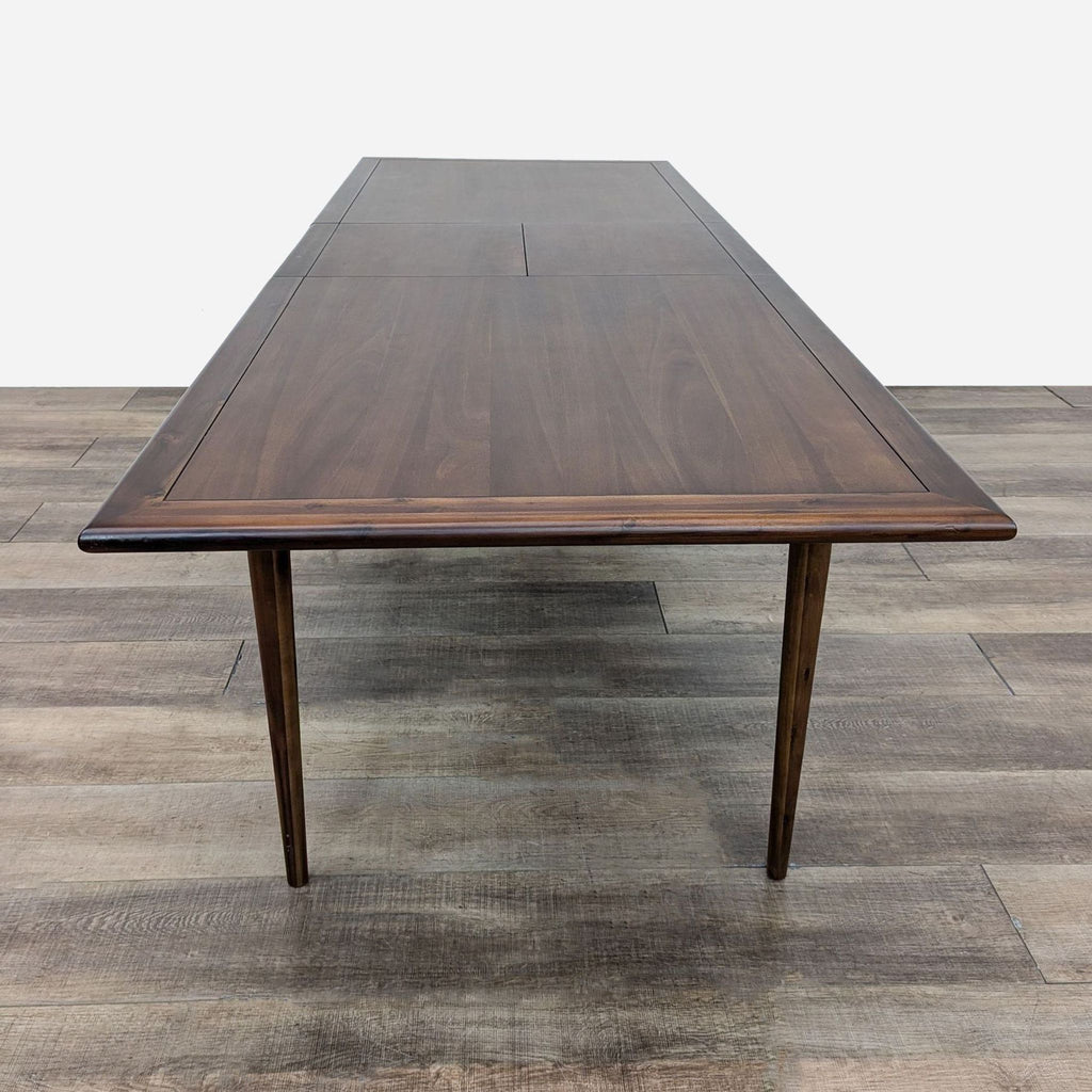 a walnut dining table with a walnut top.