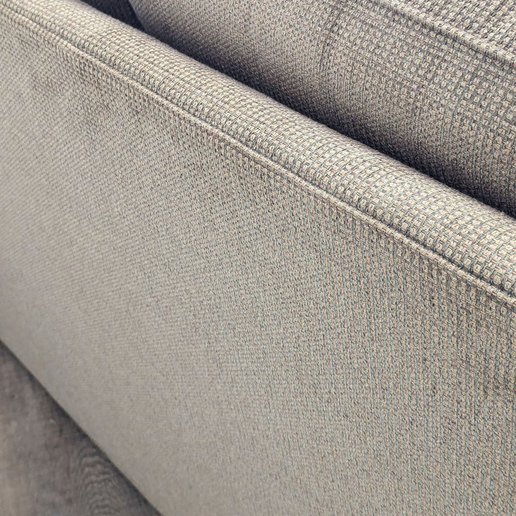 close up of the back of a grey sofa.