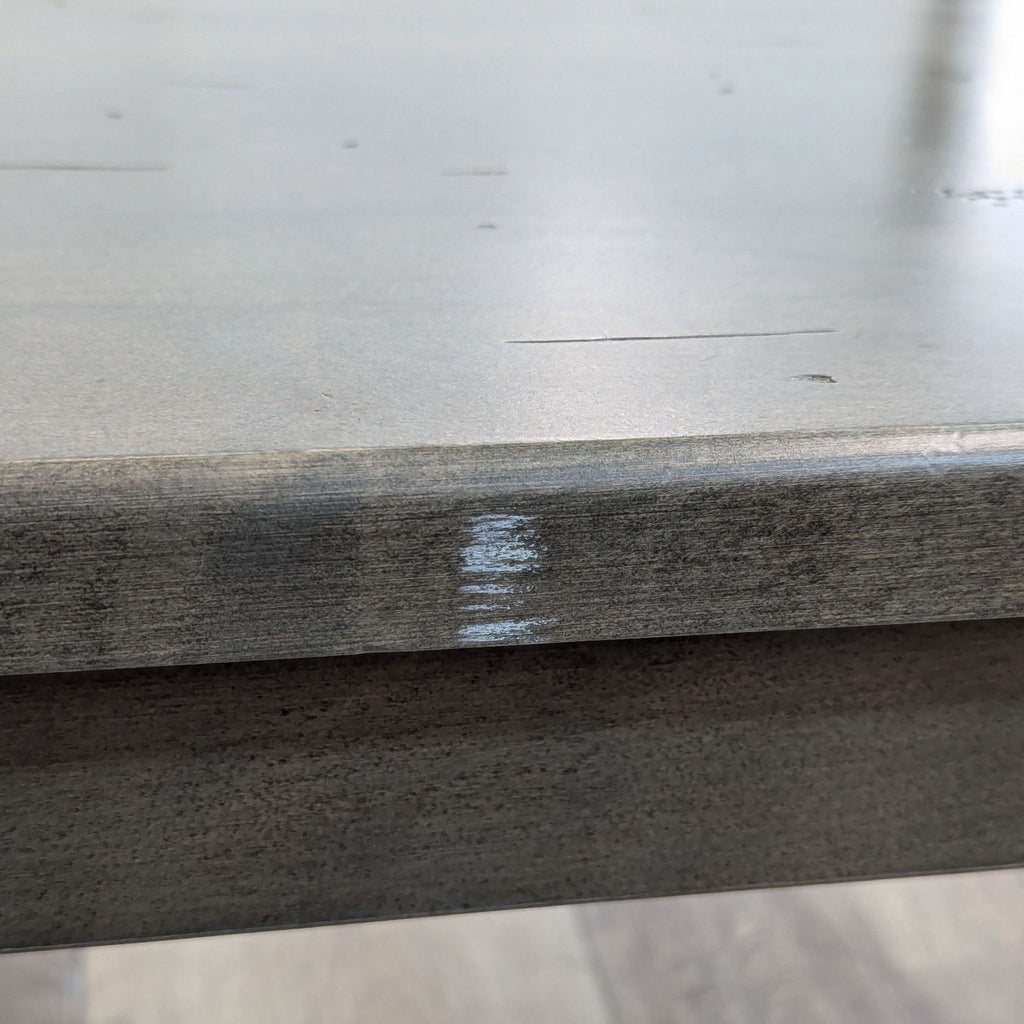 a close up of a wood table with a stain on it.