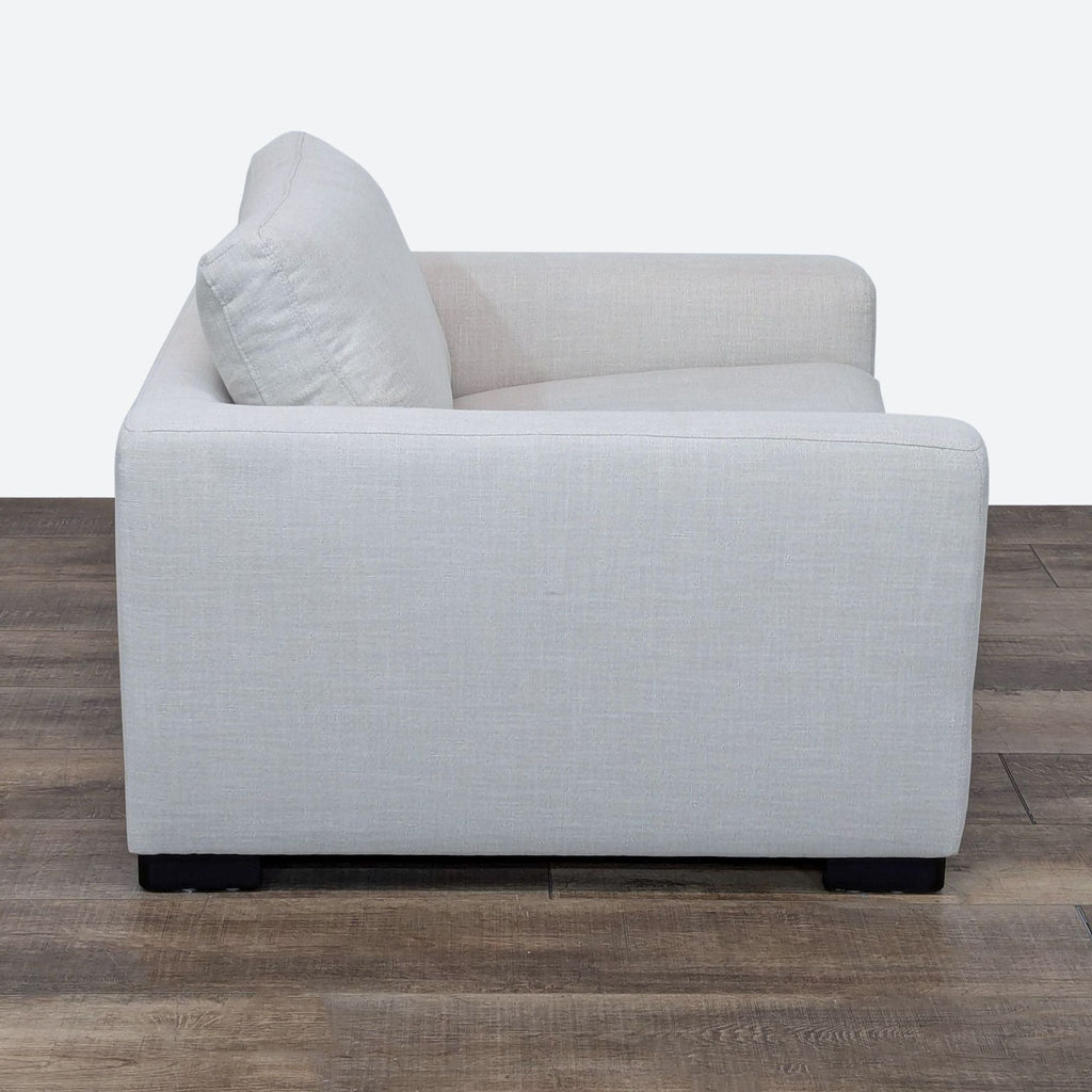 Side view of a Stone & Beam lounge chair with light gray upholstery.