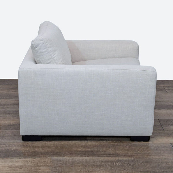 Side view of a Stone & Beam lounge chair with light gray upholstery.