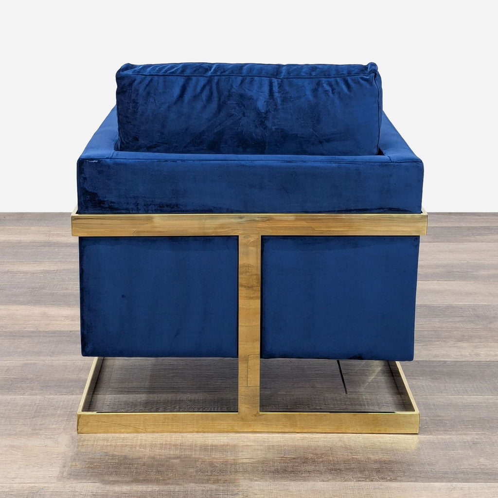 a pair of blue velvet armchairs