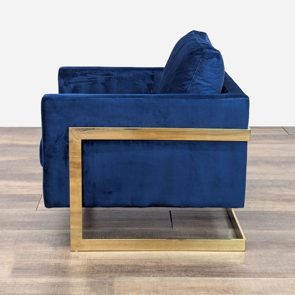 a pair of blue velvet armchairs