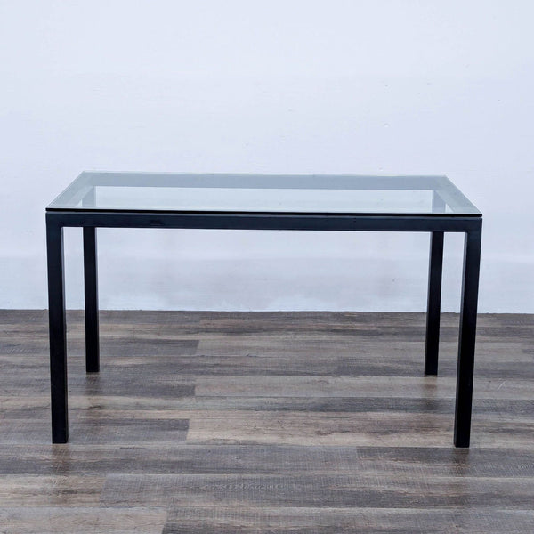 a mid century modern glass and metal coffee table