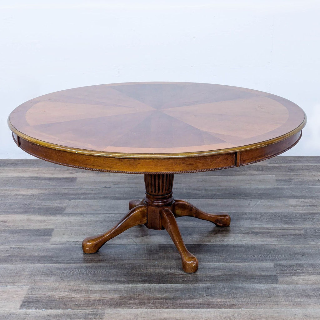 a round mahogany dining table with a round top and a round top.