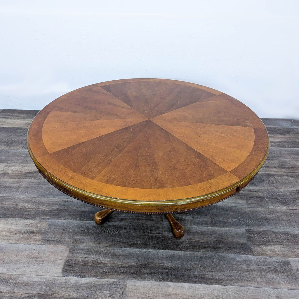 a round coffee table with a brass base and a brass base.