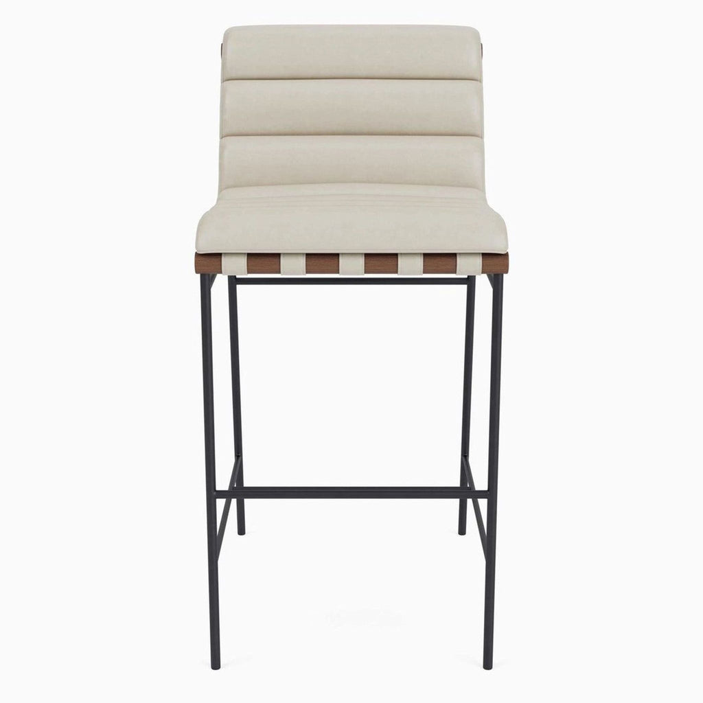 Modern counter stool with channel-tufted beige leather and solid wood dowels on a black steel frame.