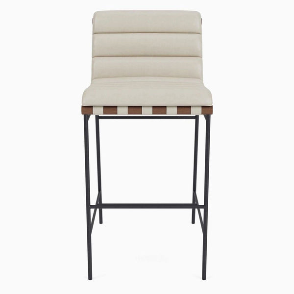 Modern counter stool with channel-tufted beige leather and solid wood dowels on a black steel frame.