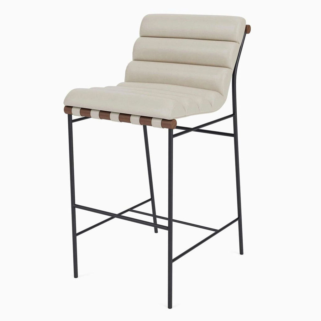 Side view of a counter stool featuring beige leather upholstery, leather straps, and a powder-coated steel frame.