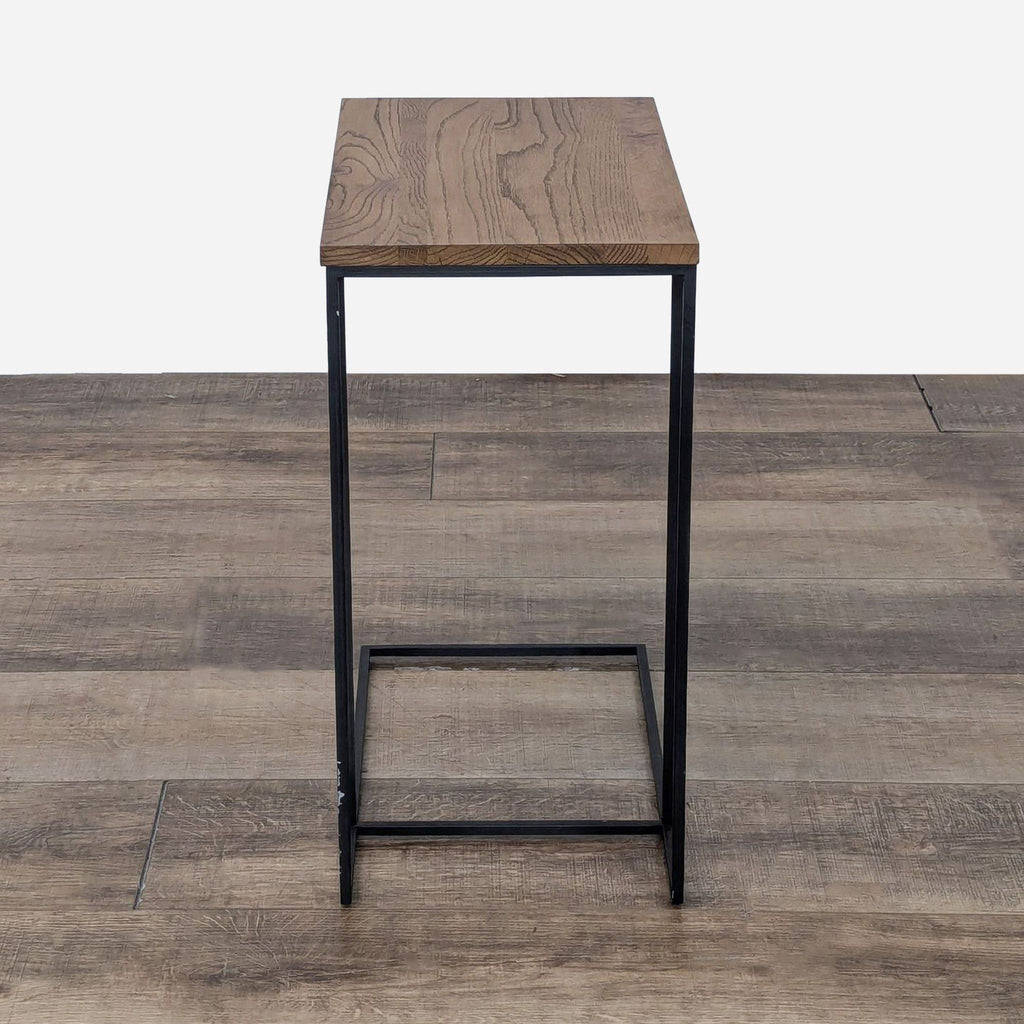 the modern side table is made from solid wood and features a metal frame.