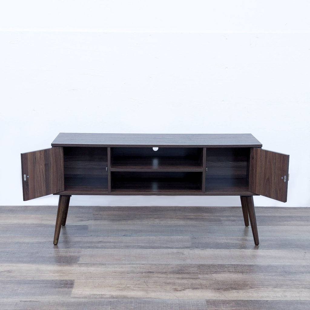 sideboard from the 1960s. the sideboard is made of walnut and has a small shelf.
