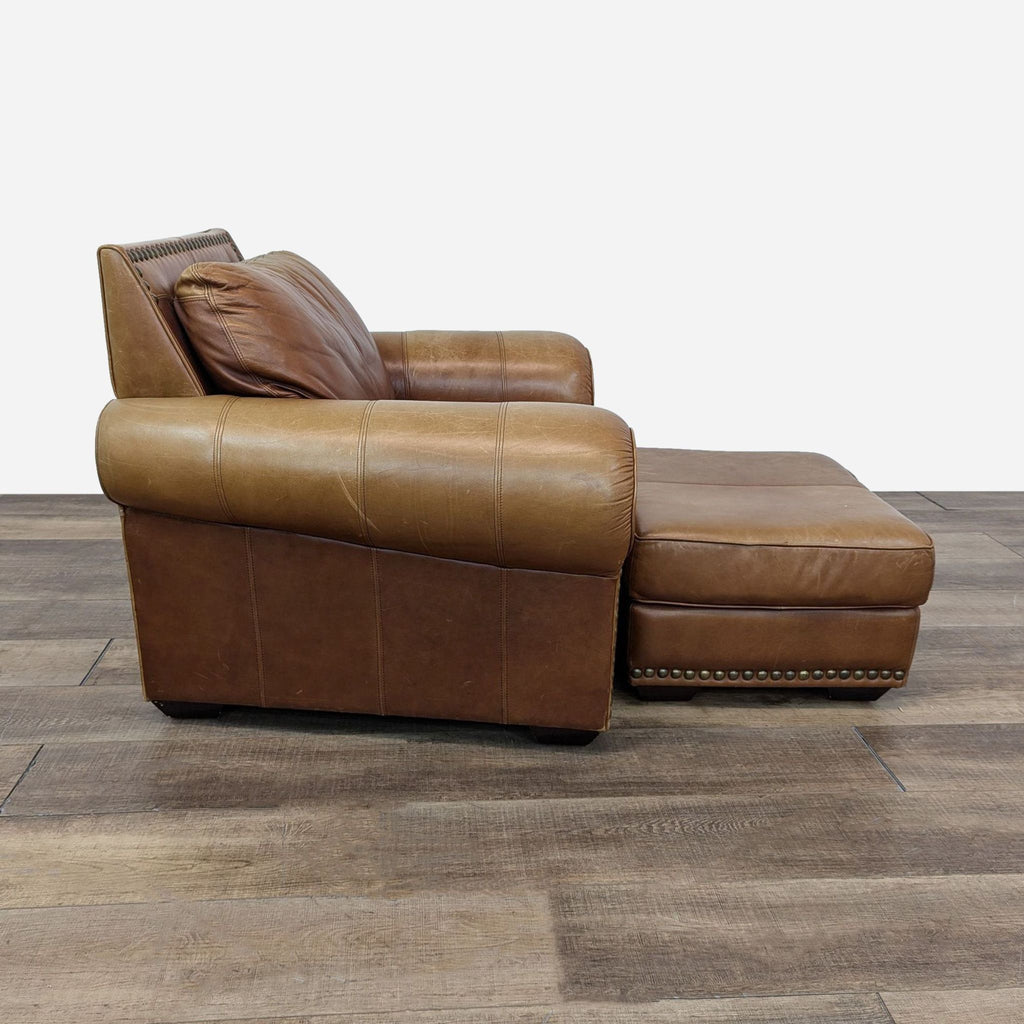 Front view of Rustin brown leather lounge chair with nailhead trim and ottoman, brand Reperch.