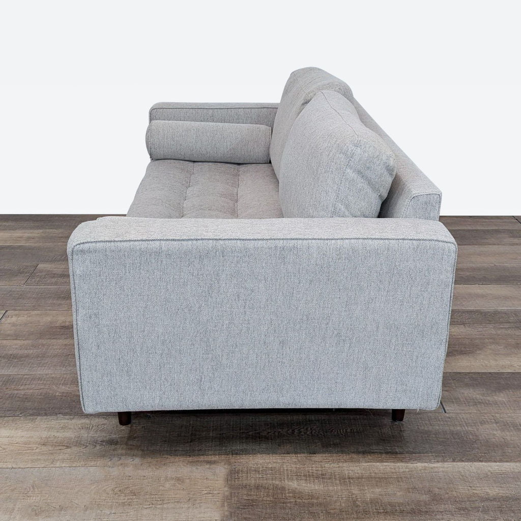 sofa is a modern, contemporary design that is made of soft grey fabric. the sofa is made