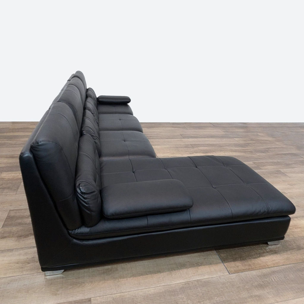 a black leather sofa by [ unused0 ], 1970s