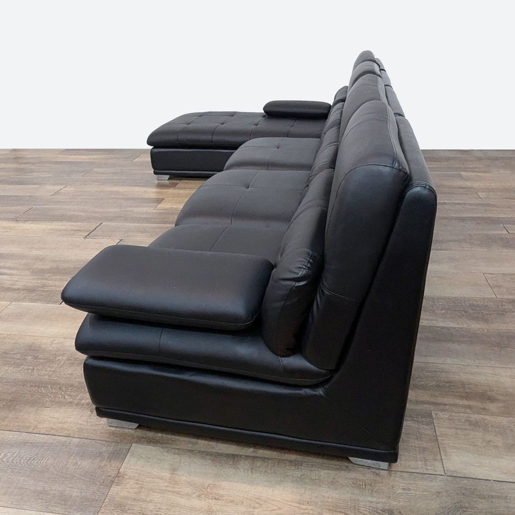 a black leather sofa set with two matching footstool and footstool.