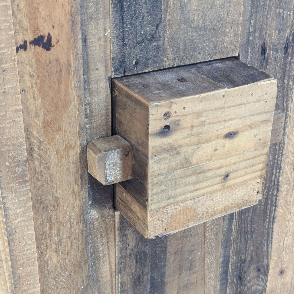 a close up of a wooden box on a wooden fence.