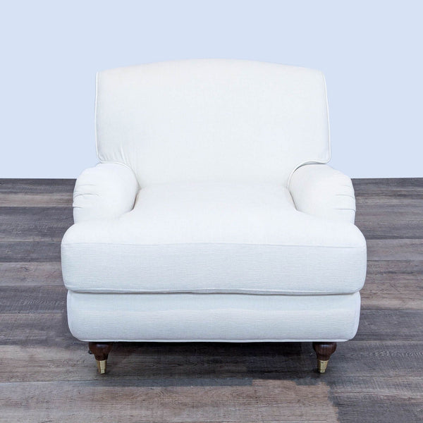 a white chair with a gold footstool