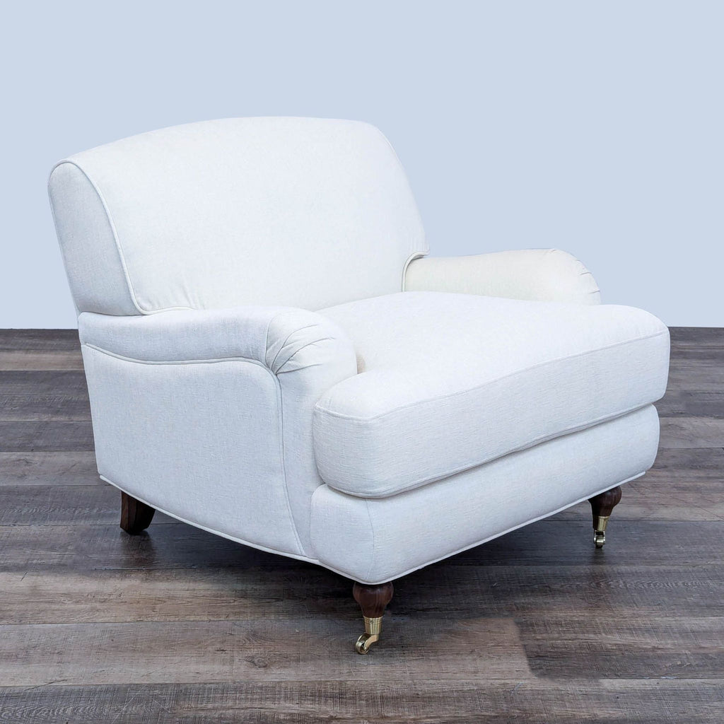 a vintage white leather chair with brass feet.