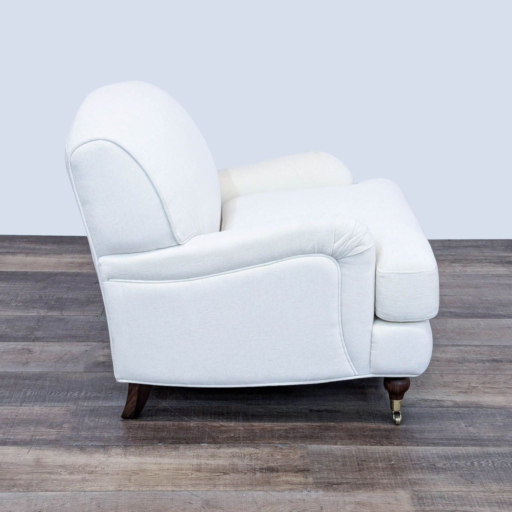 a pair of vintage lounge chairs in white leather.