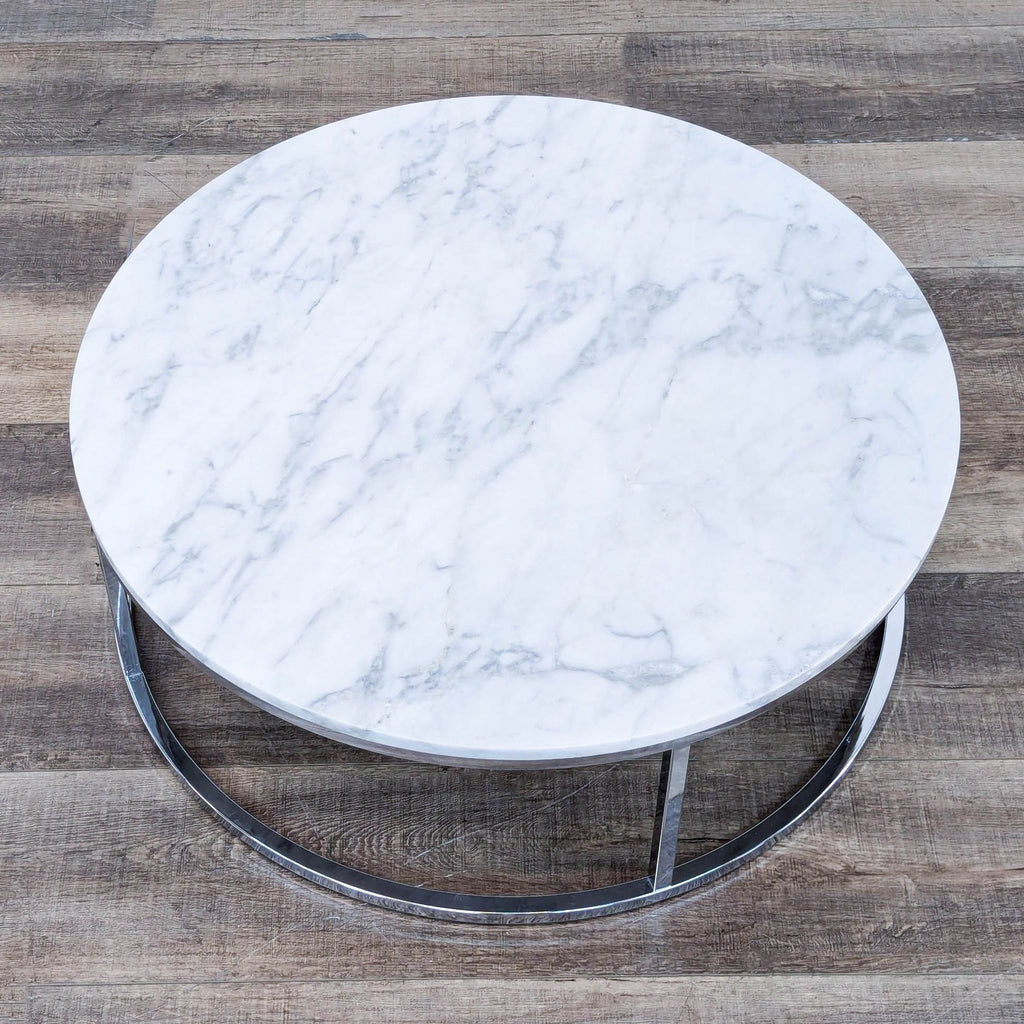 a round marble coffee table with a metal base.