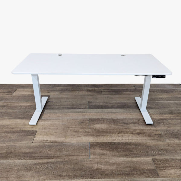 White Autonomous desk that adjusts from approximately 29" to 48" height, shown on a wooden floor.