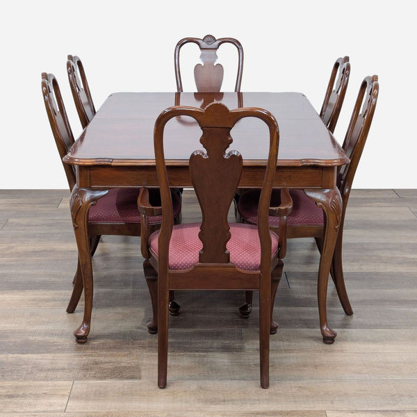 a set of six dining chairs and a table.