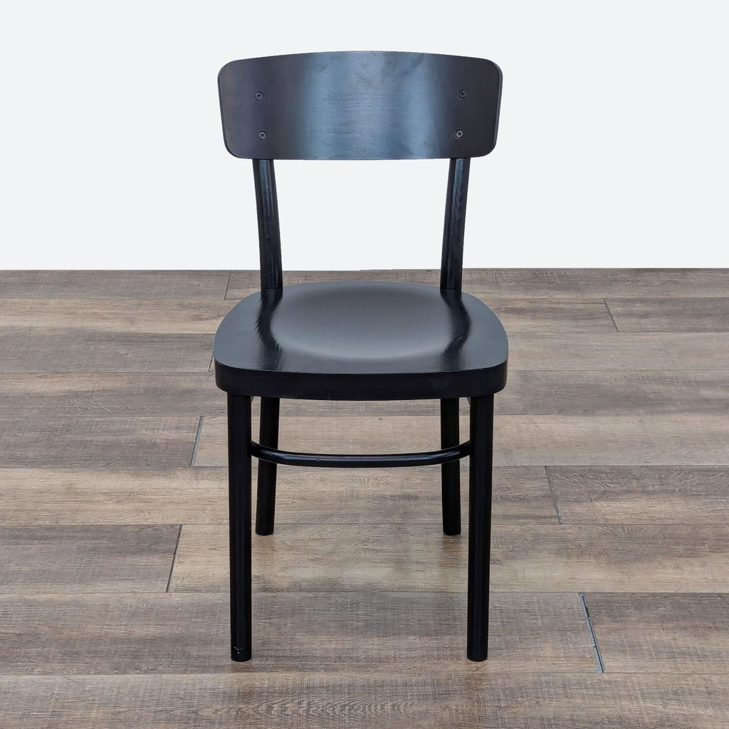 the chair is made of black wood and has a black leather seat.