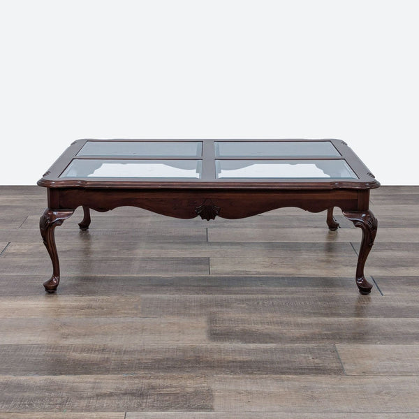 a mahogany coffee table with glass top.