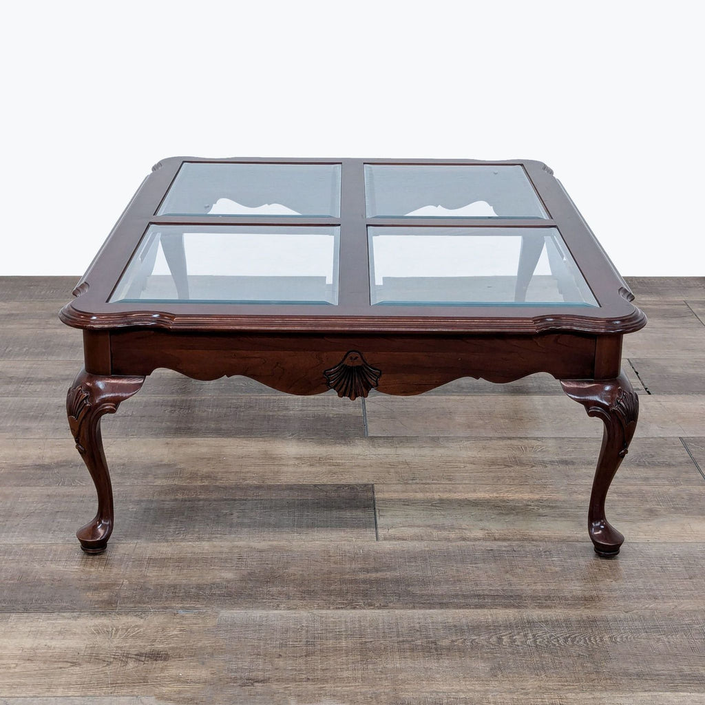 a mahogany coffee table with glass top.