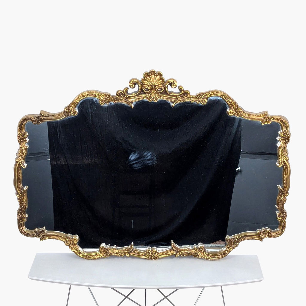 a large, gilded frame with a black velvet cover.