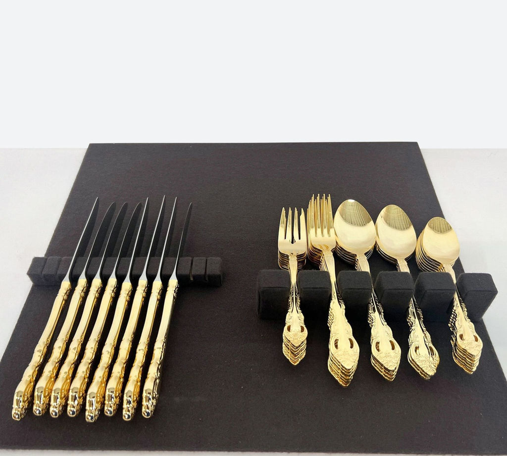 a set of gold cutlery and forks