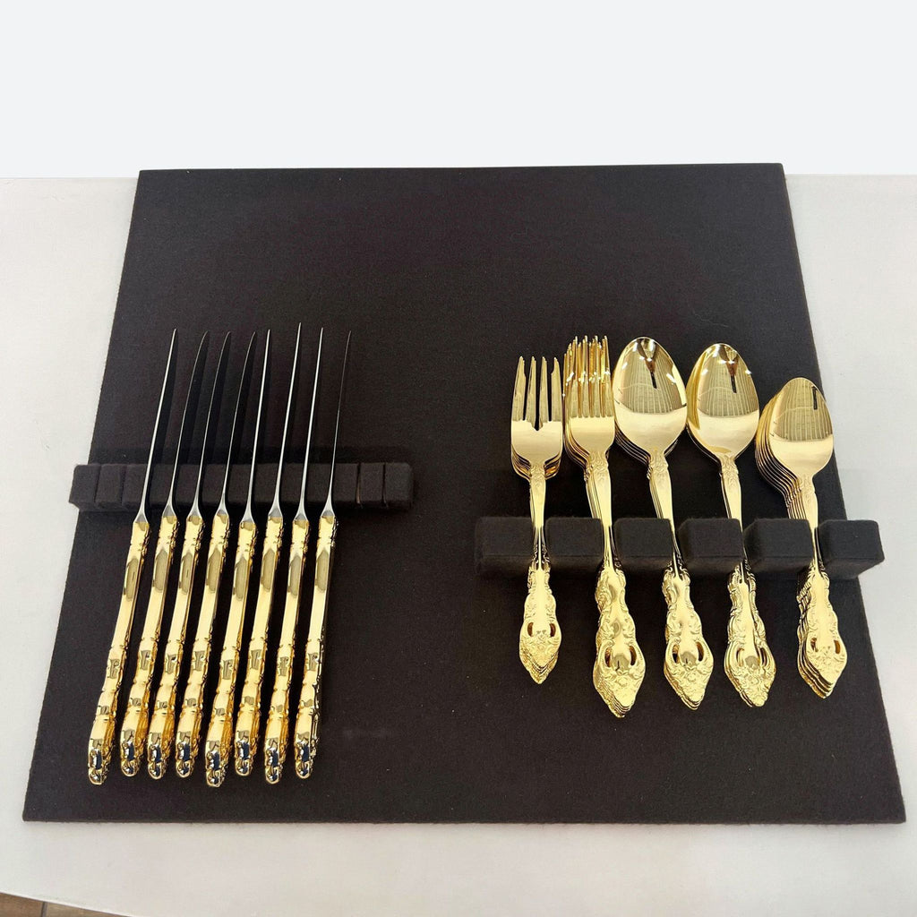 a set of gold cutlery and forks