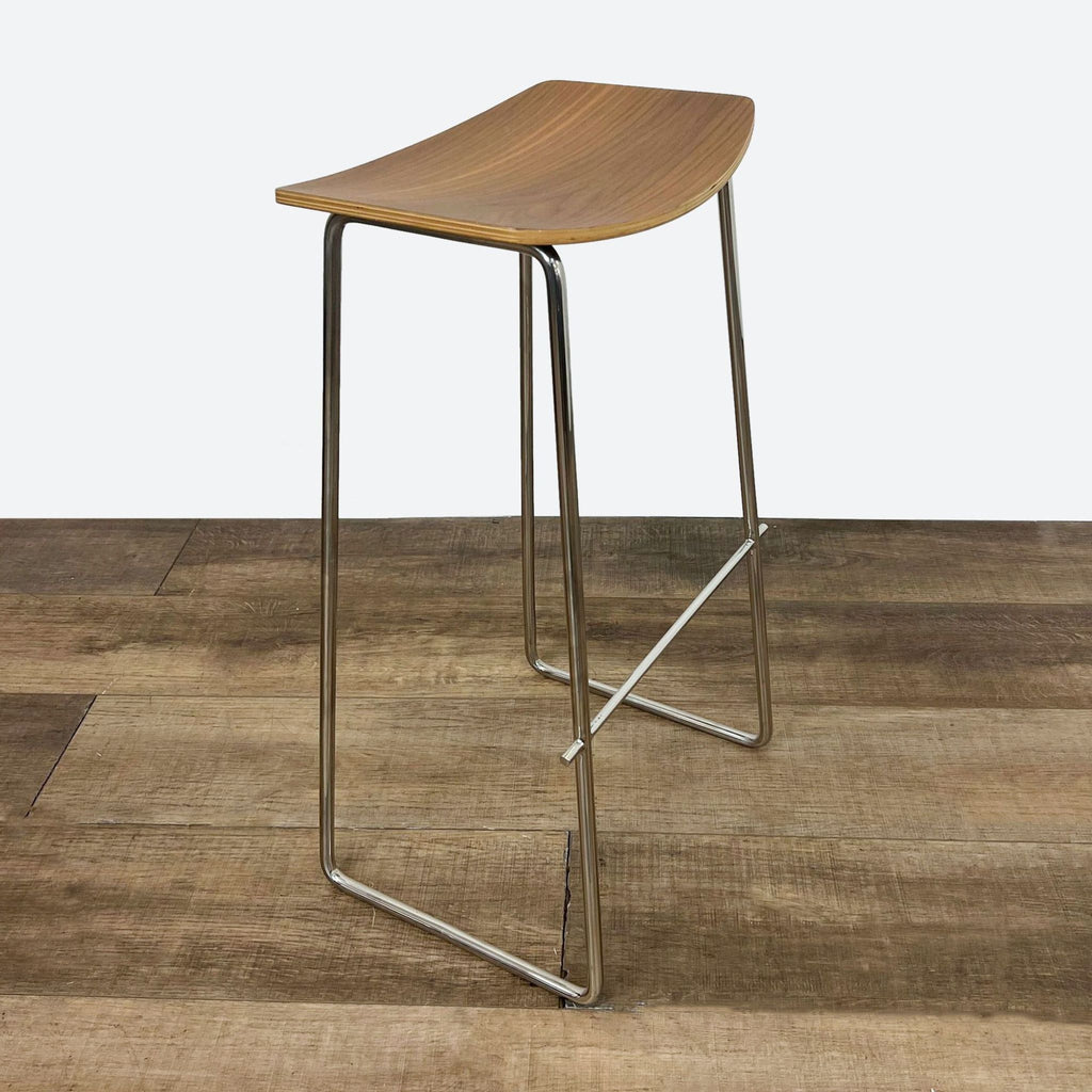 the stool is made of wood and has a curved seat and a curved seat.