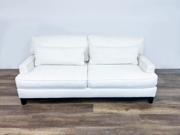 a pair of white leather sofas