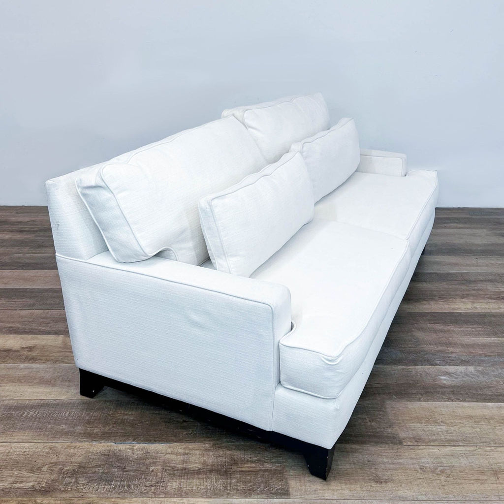 a pair of white leather sofas