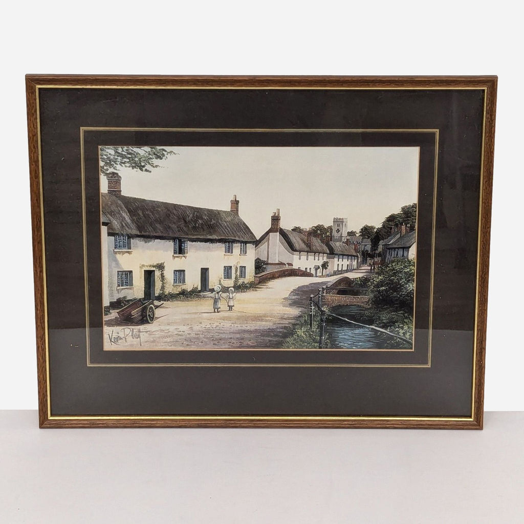 framed print of a village scene