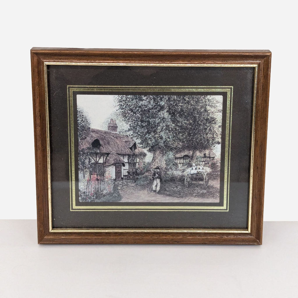 framed print of a village scene