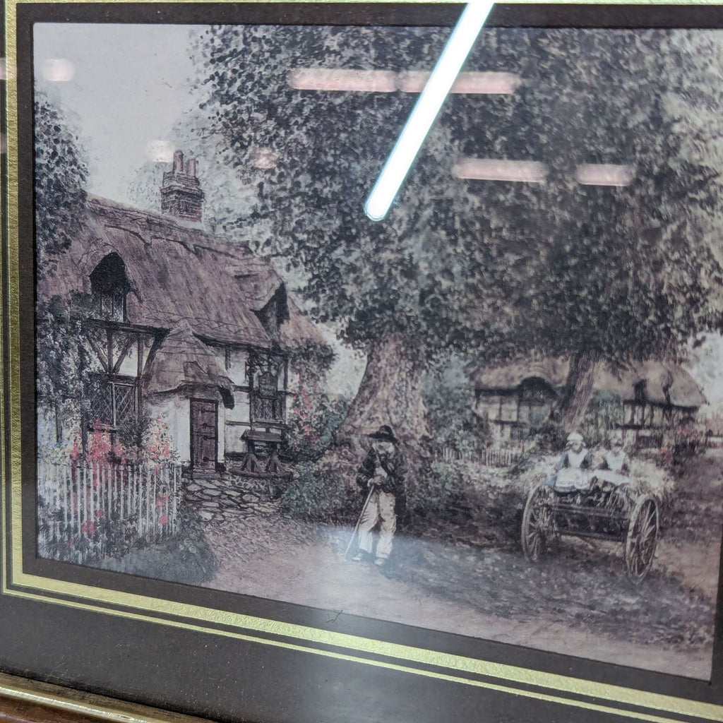 a framed print of a village scene