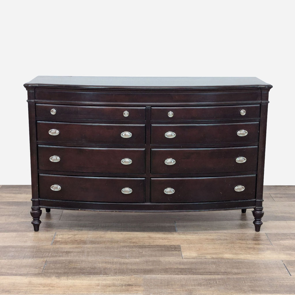 a chest of drawers with a dark wood finish.