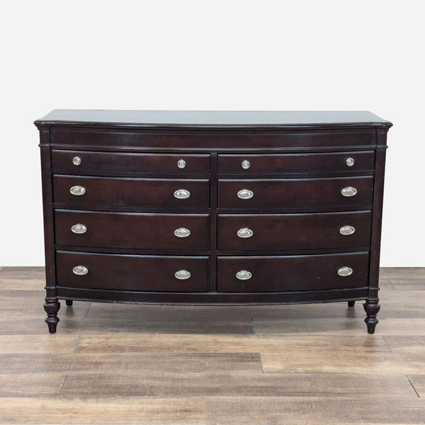 a chest of drawers with a dark wood finish.