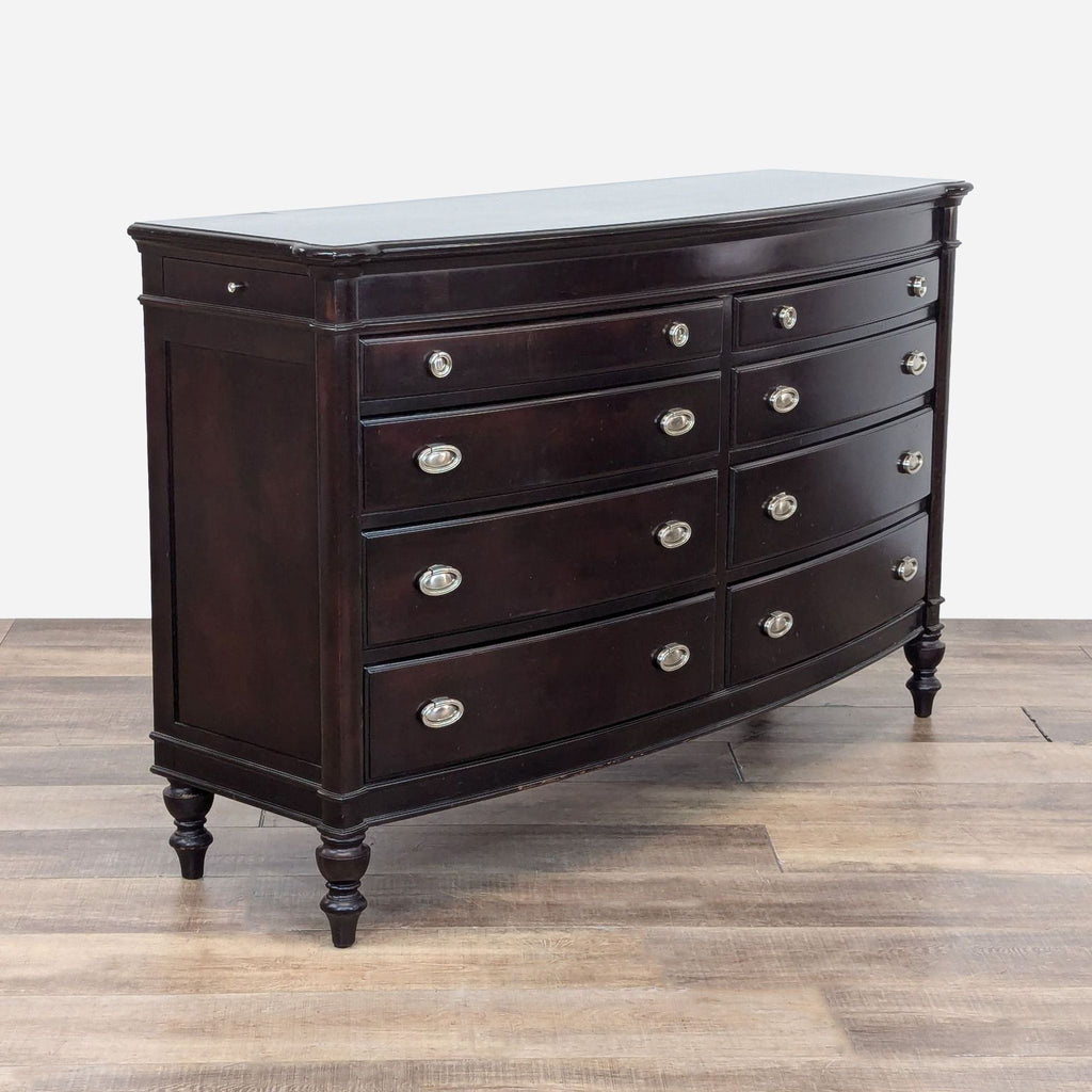 a large chest of drawers with a dark brown finish.