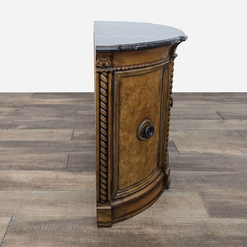 a french style side table with a round top and a black marble top.