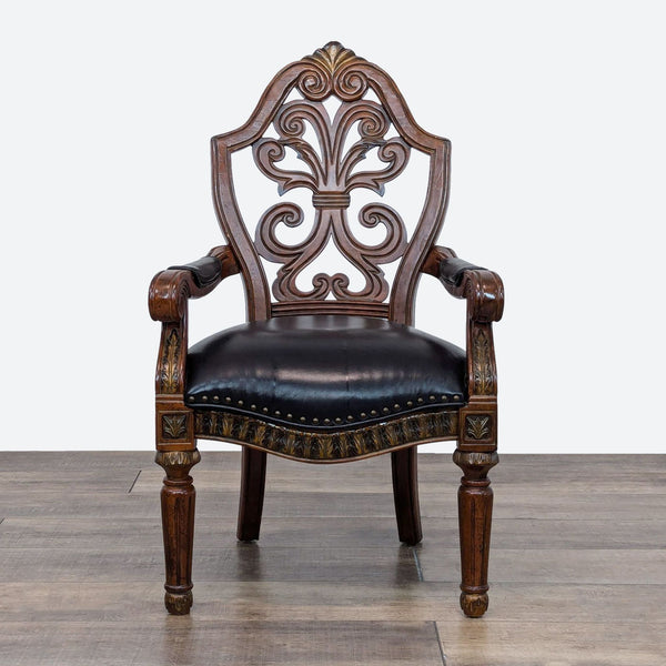 a chair with a carved back and a carved wood frame.